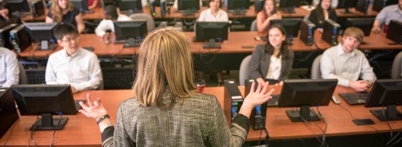 Woman presenting to computer lab students