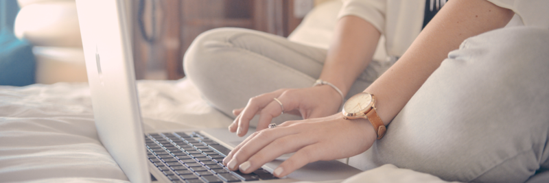 A female typing on her laptop