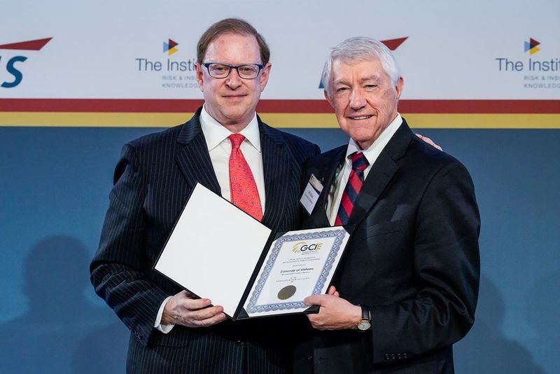IIS President & CEO Michael Morrissey (left) presents a certificate to professor William H. Rabel (right), Ph.D., FLMI, CLU, recognizing UA’s Culverhouse College of Business as a Global Center of Insurance Excellence.