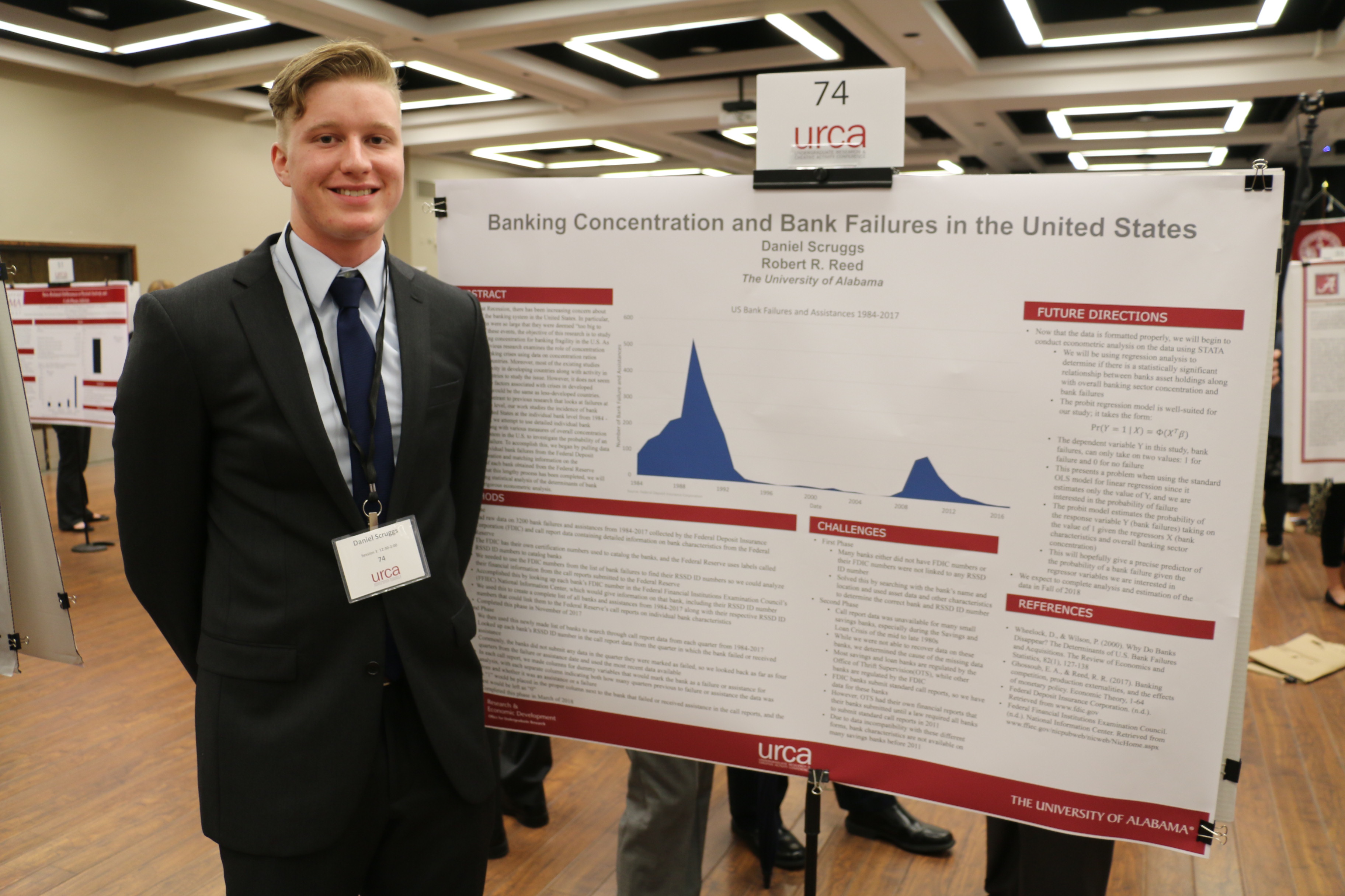 student poses with his research on national bank failures at the 2018 URCA