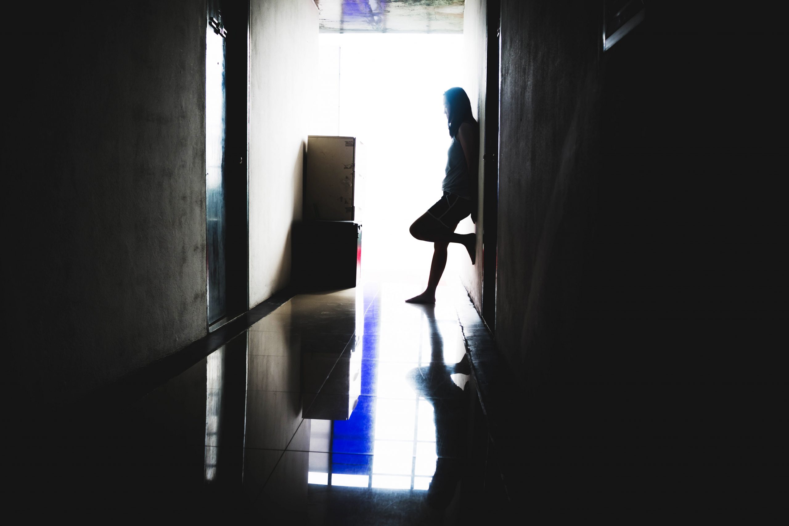 Woman standing in dark hallway