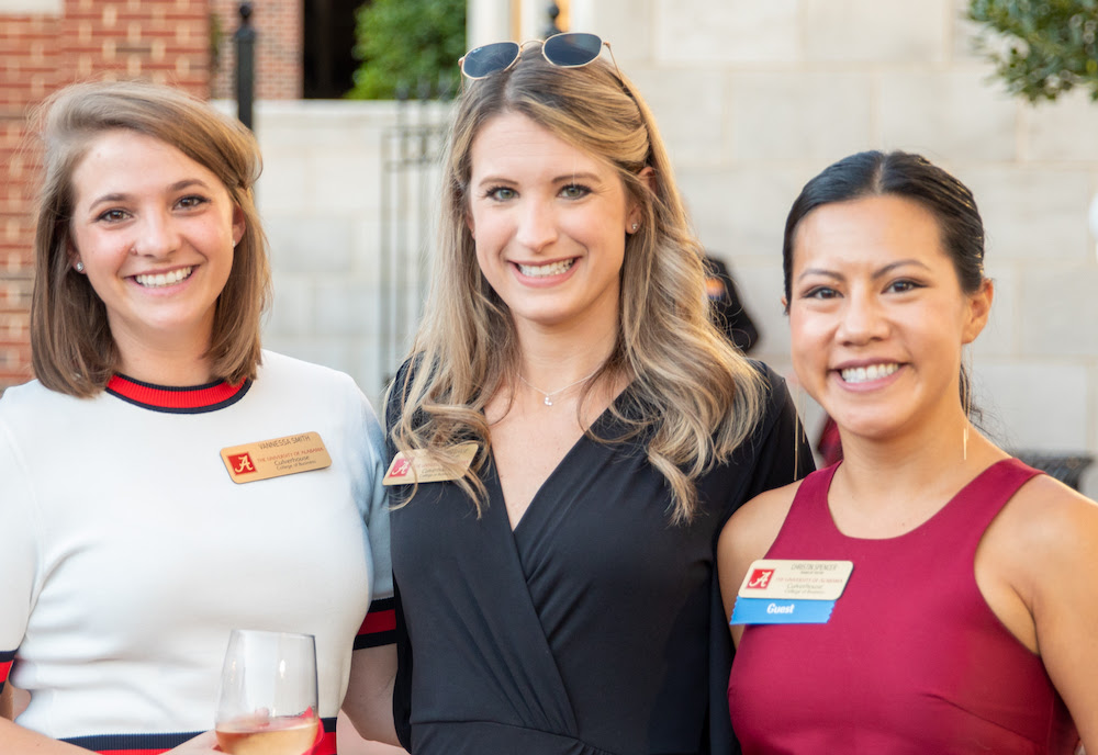 Three young female alumni of the college.