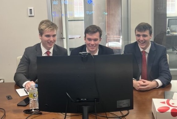 Gaines, Lindley, and Reynolds finding out that they won first place in the final round. 