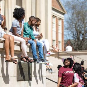 Students sitting on the steps of Gorgas Library.