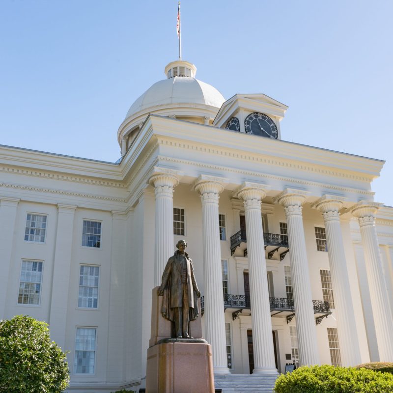 MONTGOMERY, AL - OCTOBER 30, 2017: Alabama State Capitol Building in Montgomery, Alabama with statue of Jefferson Davis in foreground