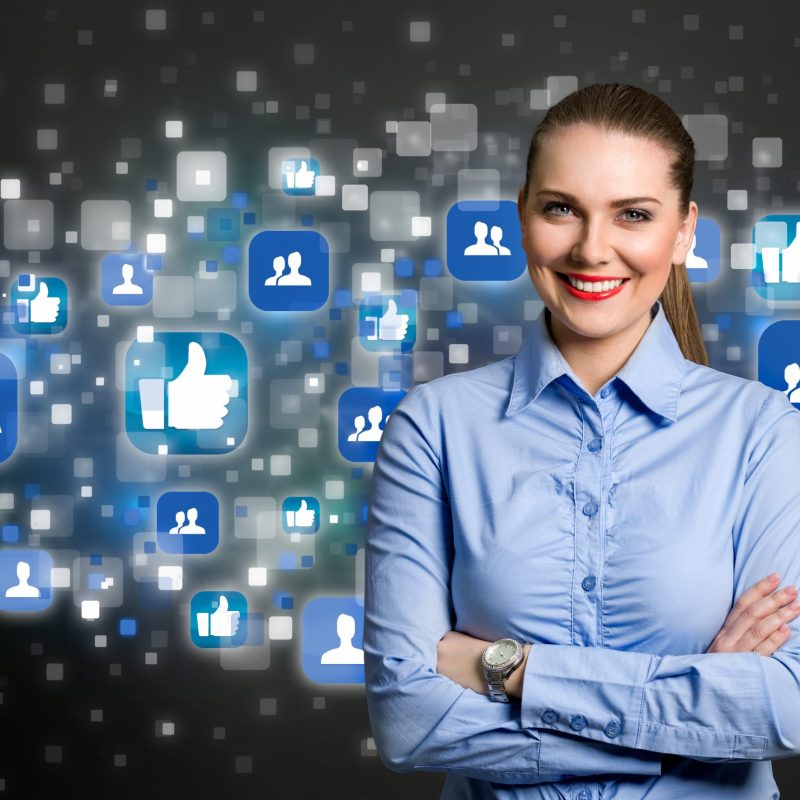 Success business woman standing with crossed arm with social icon in background